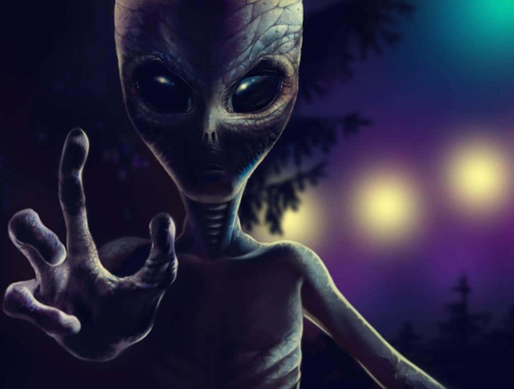 alien is reaching out hand with four fingers to grab you. At night reptiloid on background of trees and lights from spaceship.