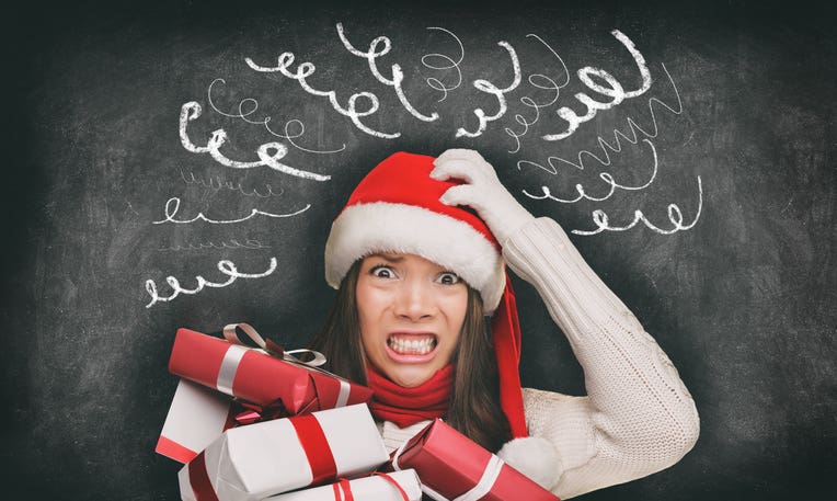 Christmas stress holiday shopping woman in santa hat stressed funny expression on black blackboard banner panorama. Anxious lady shopper late for christmas gifts stressing about the budget spending