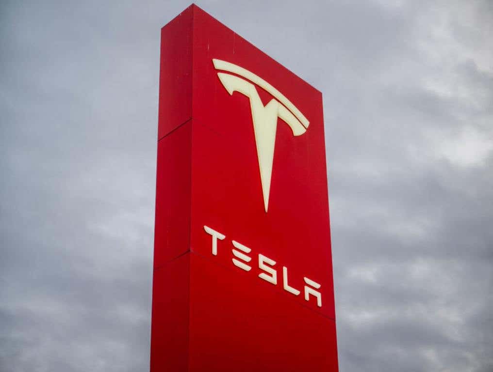 Large red Tesla Sign outside of a Tesla building