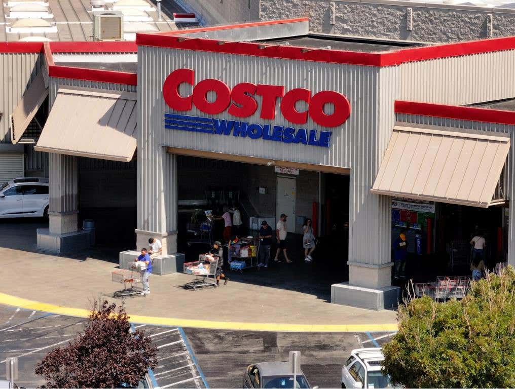 In an aerial view, the Costco logo is displayed on the exterior of a Costco store. Costco's return policy has limits.