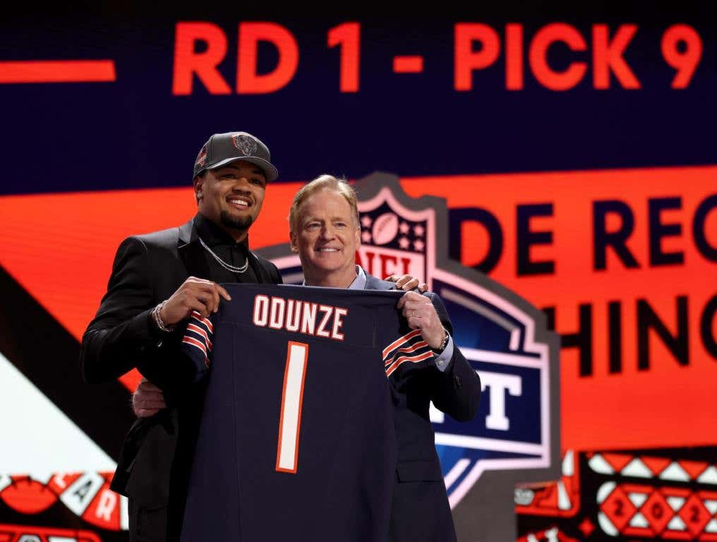 Former Bishop Gorman grad holding up his Bears' jersey at the NFL draft.