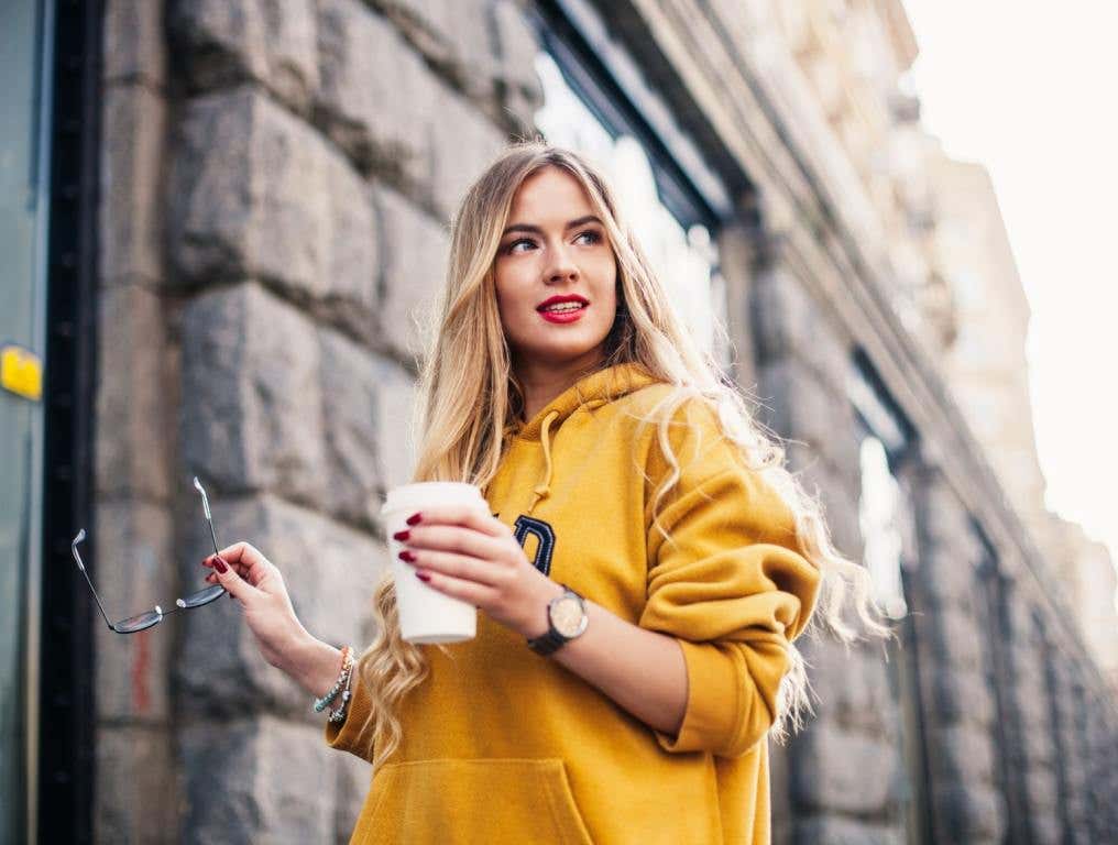 Woman in hoodie with coffee. You won't be short of things to do during the months of September, October and November, either. Here's your fall checklist and things to love about the season.