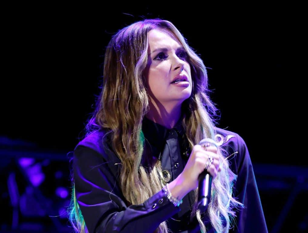 Carly Pearce wearing a black leather outfit on stage.