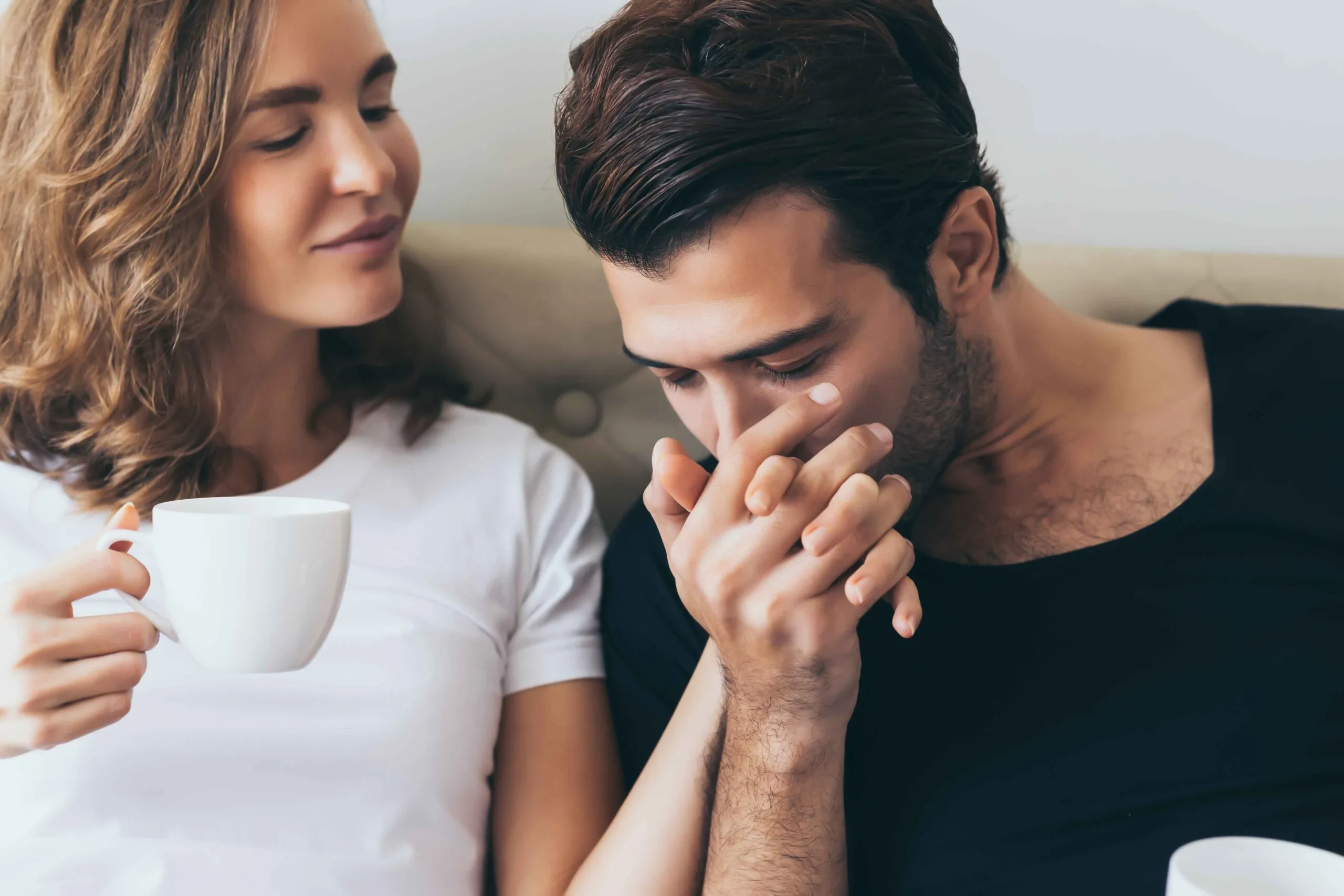 Man kissing his girlfriend's hand 