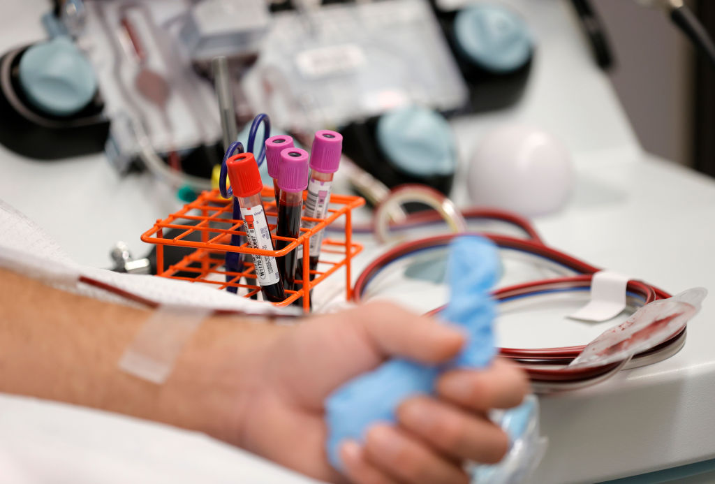 A man donates blood at Vitalant blood donation center