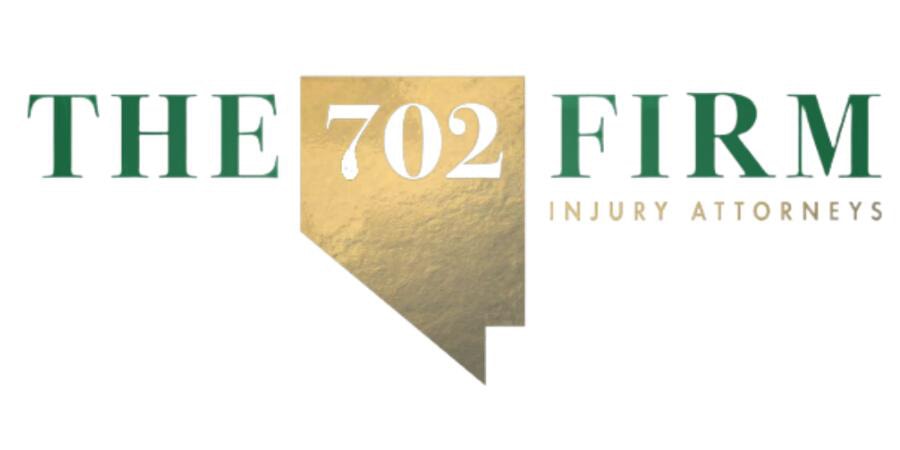 The702Firm Injury Attorneys Green The next to a Nevada gold cutout of the state with white 702 in the top center follow by The Firm in green letters. Small Injury attorneys are under the word firm.